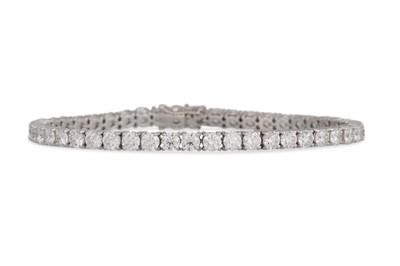 Lot 233 - A DIAMOND LINE BRACELET, the brilliant cut...