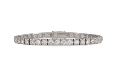Lot 235 - A DIAMOND LINE BRACELET, the brilliant cut...