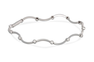 Lot 238 - A DIAMOND BRACELET, of wavy form, collet set...