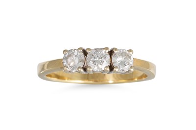 Lot 309 - A THREE STONE DIAMOND RING, the brilliant cut...