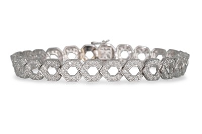 Lot 83 - A DIAMOND BRACELET, comprising shaped links...