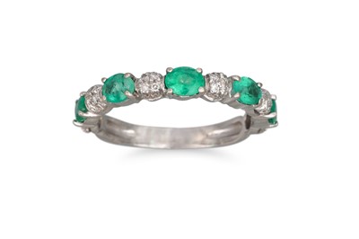 Lot 256 - AN EMERALD AND DIAMOND HALF ETERNITY RING, set...