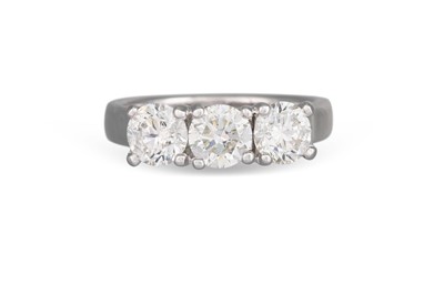 Lot 318 - A THREE STONE DIAMOND RING, the brilliant cut...