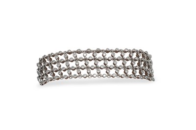 Lot 371 - A DIAMOND SET BRACELET, of open work lattice...