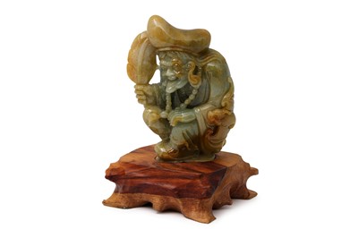 Lot 489 - A CHINESE CARVED JADE FIGURE, of a crouching...