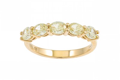 Lot 192 - AN OVAL FANCY YELLOW DIAMOND FIVE STONE RING,...