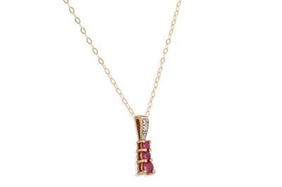 Lot 40 - A DIAMOND AND RUBY DROP PENDANT, mounted in...