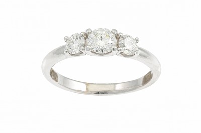 Lot 307 - A DIAMOND THREE STONE RING, the brilliant cut...