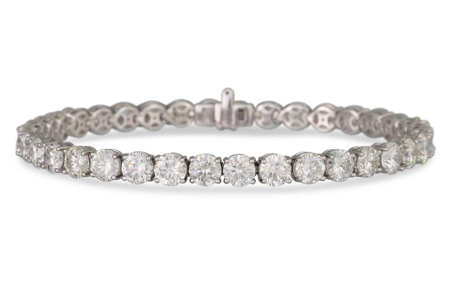 Lot 351 - A DIAMOND LINE BRACELET, the brilliant cut...