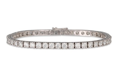 Lot 352 - A DIAMOND LINE BRACELET, the brilliant cut...