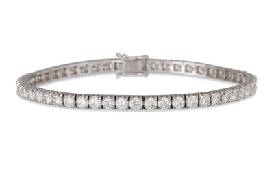 Lot 353 - A DIAMOND LINE BRACELET, the brilliant cut...