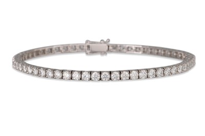 Lot 357 - A DIAMOND LINE BRACELET, the brilliant cut...