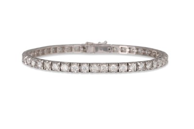 Lot 358 - A DIAMOND LINE BRACELET, the brilliant cut...