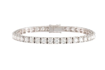 Lot 317 - A DIAMOND LINE BRACELET, the brilliant cut...