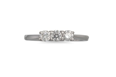 Lot 78 - A DIAMOND THREE STONE RING, the round...
