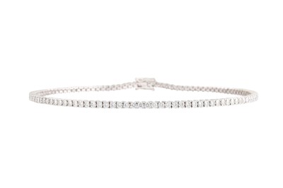 Lot 388 - A DIAMOND LINE BRACELET, the round brilliant...