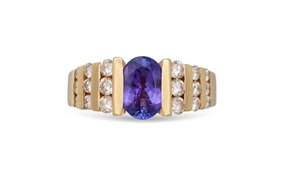 Lot 210 - A TANZANITE AND DIAMOND RING, the oval...
