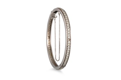 Lot 219 - A DIAMOND SET BANGLE, the brilliant cut...