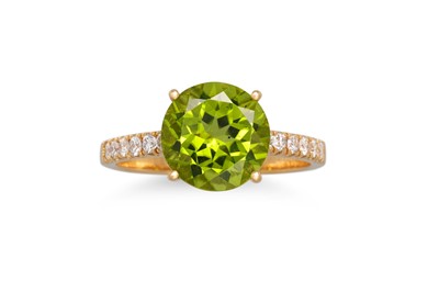 Lot 179 - A PERIDOT AND DIAMOND RING, the round peridot...