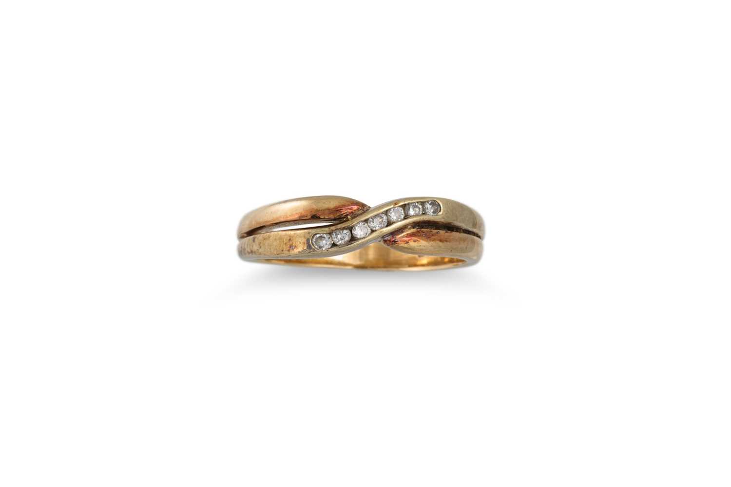 Lot 14 - A DIAMOND SEVEN STONE CROSS OVER DRESS RING,...