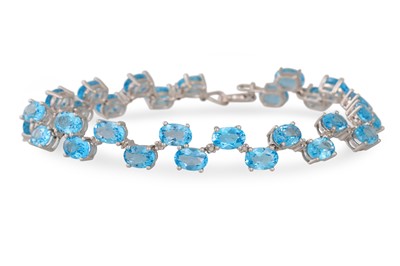 Lot 26 - A DIAMOND AND TOPAZ BRACELET, the round topaz...