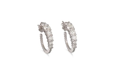 Lot 229 - A PAIR OF DIAMOND HOOP EARRINGS, the graduated...