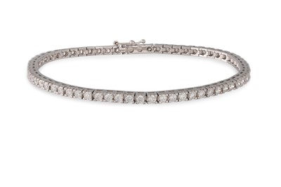 Lot 232 - A DIAMOND LINE BRACELET, the brilliant cut...