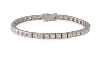 Lot 234 - A DIAMOND LINE BRACELET, the brilliant cut...