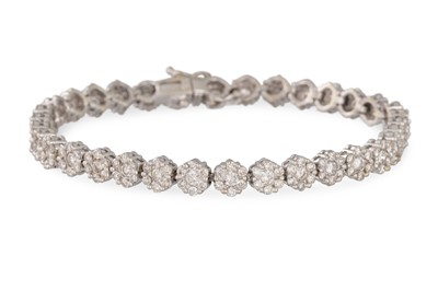 Lot 248 - A DIAMOND LINE BRACELET, each link in a floral...