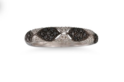 Lot 150 - A PAVÉ DIAMOND RING, set with black & white...