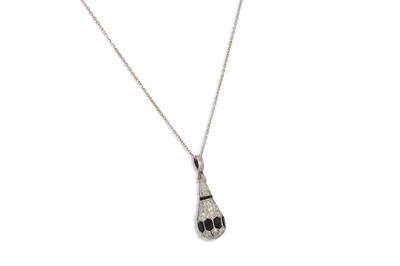 Lot 317 - A DIAMOND AND ONYX PENDANT, mounted in white...