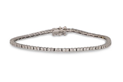 Lot 463 - A DIAMOND LINE BRACELET, mounted in 9ct white...