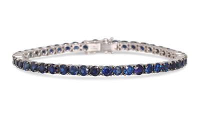 Lot 226 - A SAPPHIRE LINE BRACELET, the circular stones...