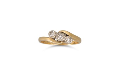 Lot 62 - A THREE STONE DIAMOND RING, mounted in yellow...