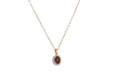 Lot 33 - A GARNET PENDANT, the oval garnet mounted in...