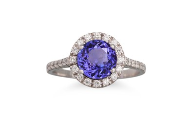 Lot 274 - A TANZANITE AND DIAMOND RING, the circular...