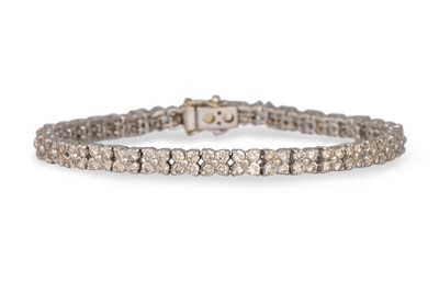 Lot 45 - A DIAMOND LINE BRACELET, comprising clusters,...