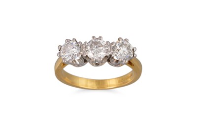 Lot 82 - A THREE STONE DIAMOND RING, the brilliant cut...