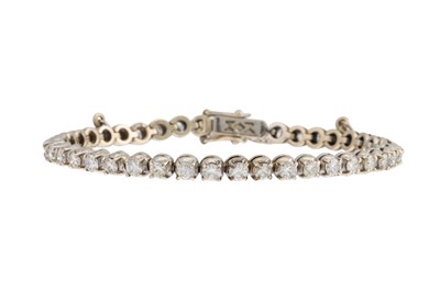 Lot 223 - A DIAMOND LINE BRACELET, set with round...