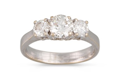 Lot 223 - A THREE STONE DIAMOND RING, the brilliant cut...