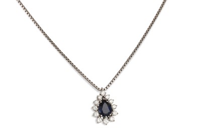 Lot 265 - A DIAMOND AND SAPPHIRE CLUSTER PENDANT, the...