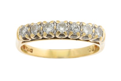 Lot 105 - A SEVEN STONE DIAMOND RING, the brilliant cut...