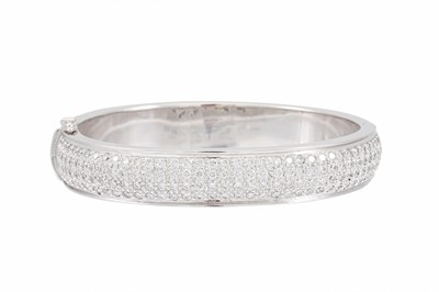 Lot 362 - A DIAMOND SET BANGLE, Pave set with brilliant...