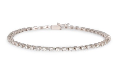 Lot 206 - A DIAMOND LINE BRACELET, the brilliant cut...
