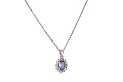 Lot 155 - A TANZANITE AND DIAMOND CLUSTER PENDANT,...