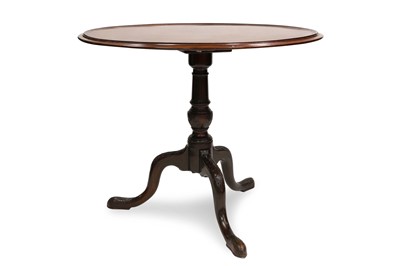 Lot 486 - A GEORGE III CIRCULAR MAHOGANY TIP UP...