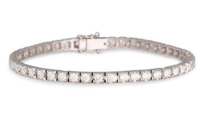 Lot 412 - A DIAMOND LINE BRACELET, the brilliant cut...