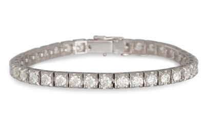 Lot 413 - A DIAMOND LINE BRACELET, the brilliant cut...