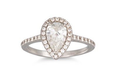 Lot 336 - A DIAMOND HALO CLUSTER RING, the pear shaped...