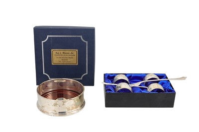 Lot 460 - FOUR SILVER NAPKIN RINGS, together with a...